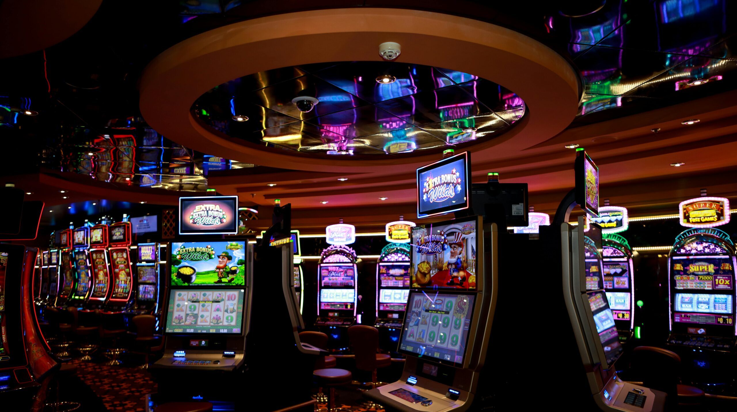 Vibrant casino floor with colorful slot machines and bright lights capturing a lively gaming atmosphere.